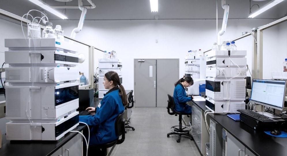 TLC analysts working at HPLC instruments in the analytical lab